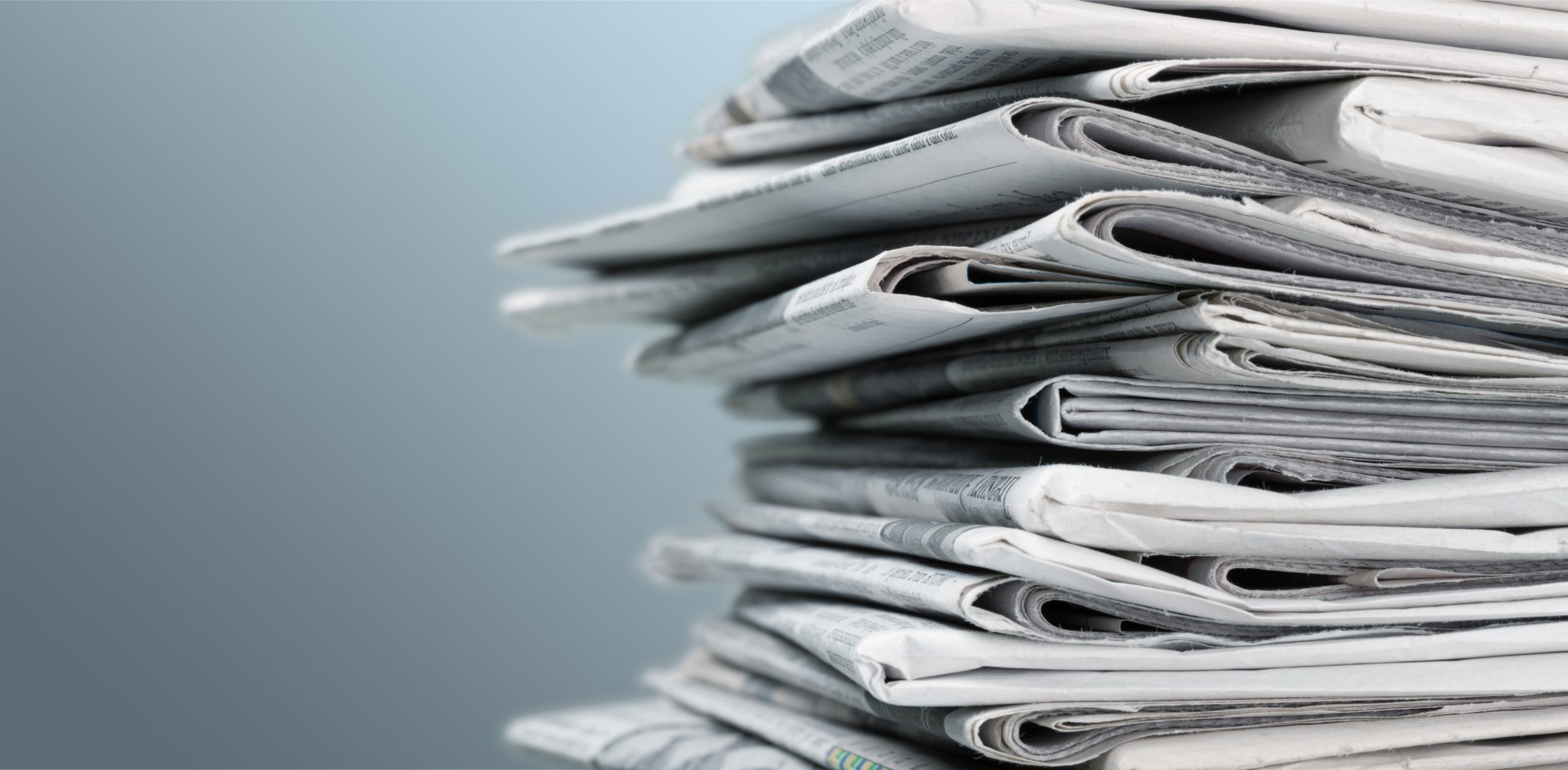 Pile of newspapers on white background