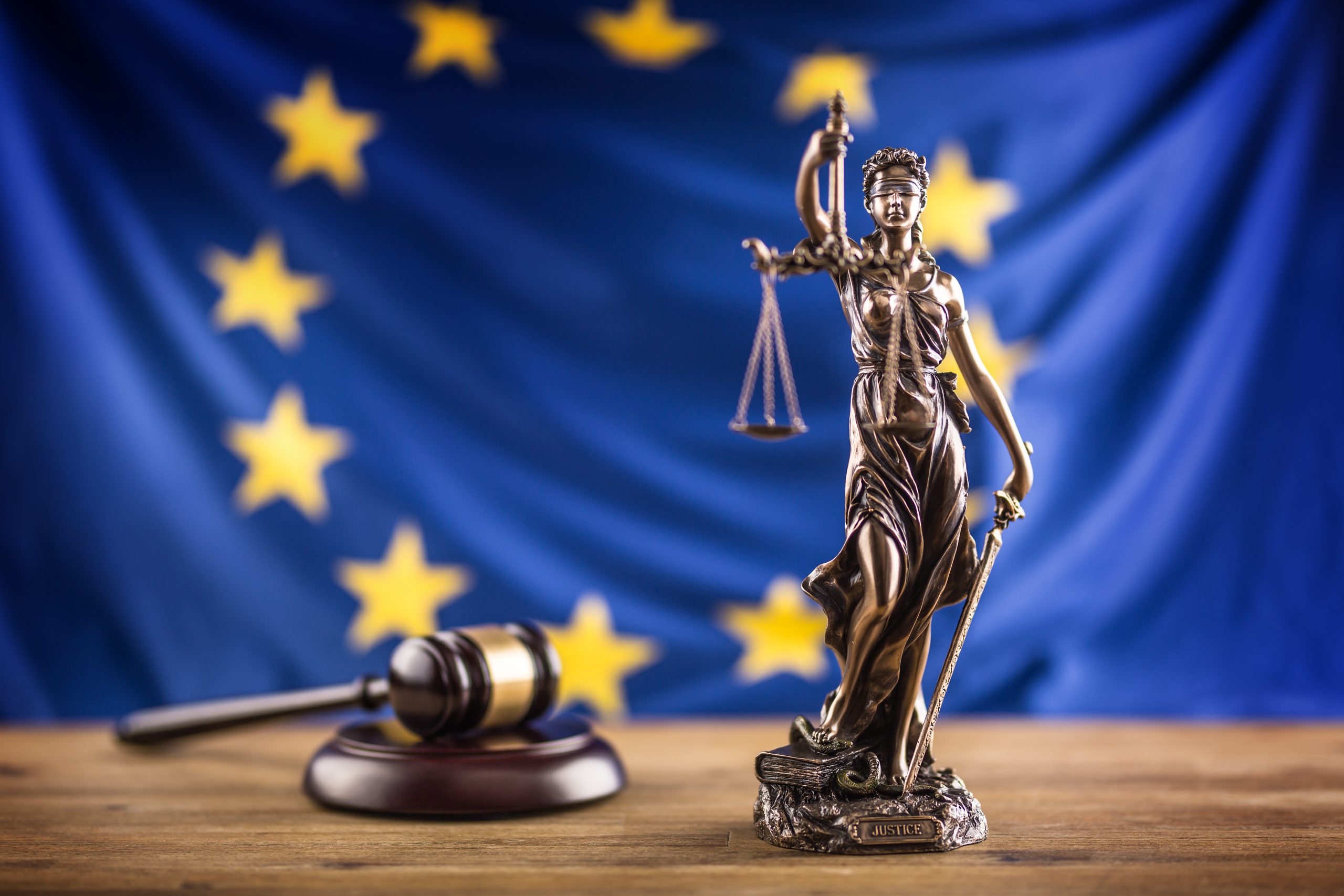 Lady Justice and European Union flag. Symbol of law and justice with EU Flag.
